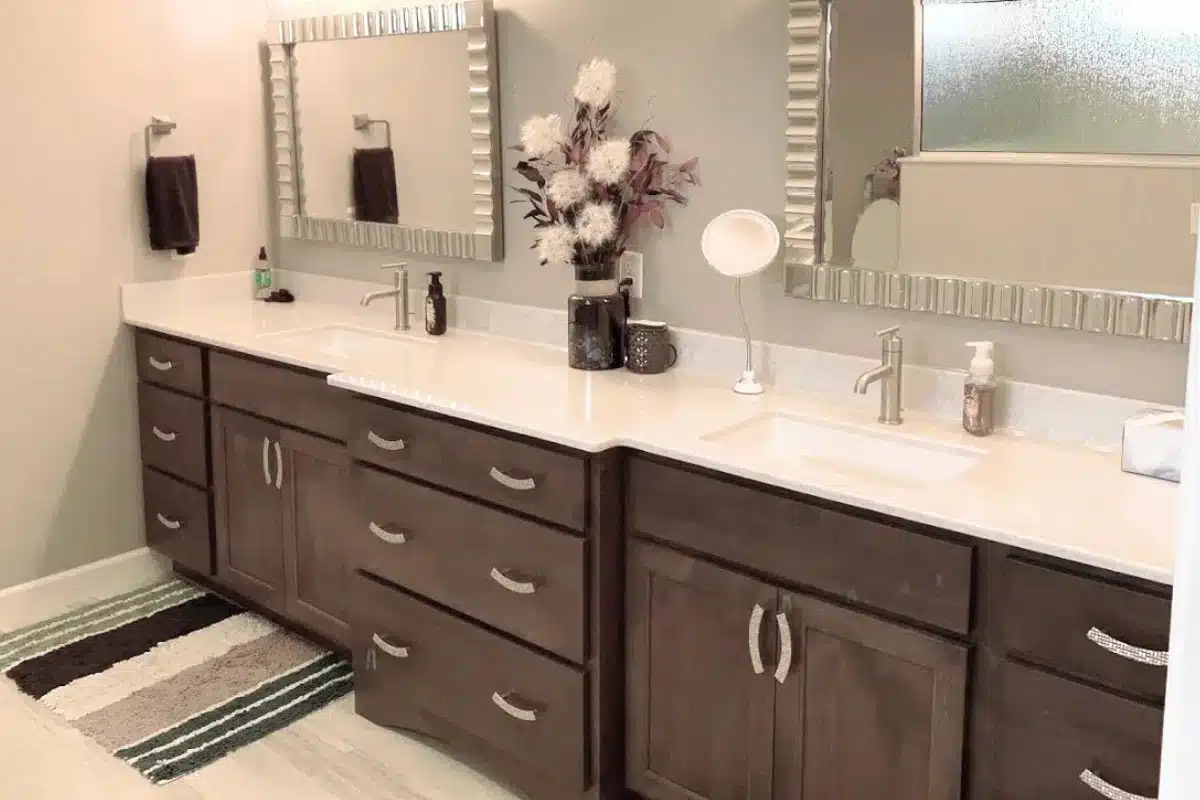 Custom bathroom cabinet installation in Baltimore, MD featuring a double-sink vanity with wood cabinetry, modern hardware, and a wide countertop.