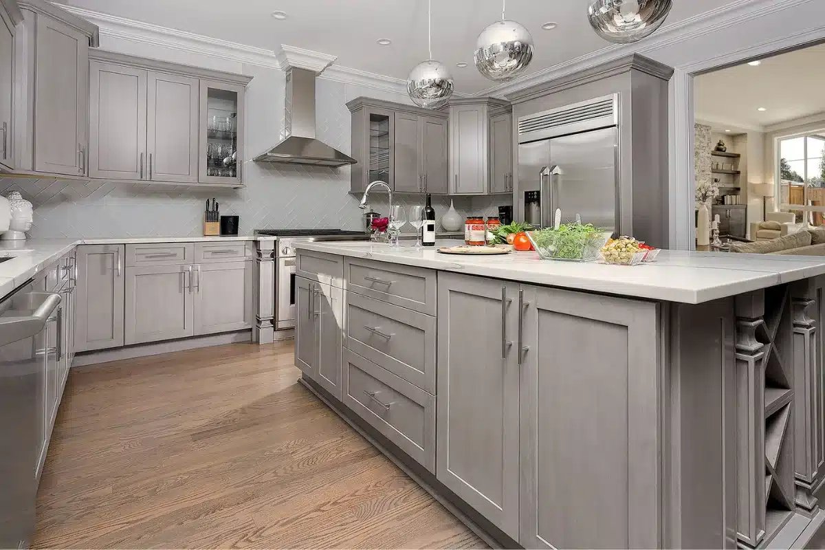 Luxury gray-cabinet kitchen with newly updated hardwood flooring, showcasing professional kitchen flooring replacement in Baltimore, MD.