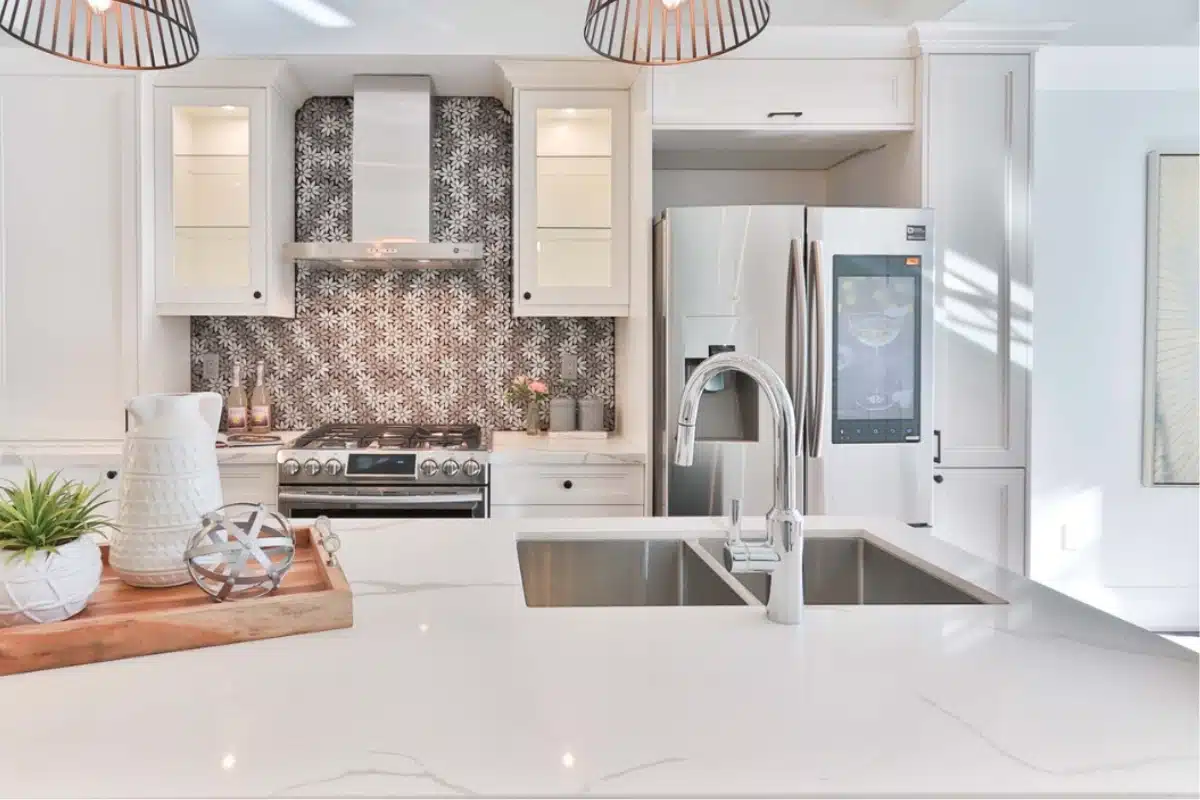 Bright modern kitchen featuring a double-basin sink, updated faucet, and stainless-steel appliances, highlighting professional kitchen plumbing services in Baltimore, MD.