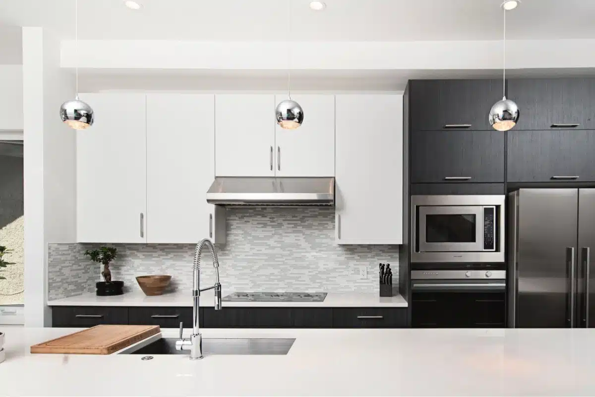 Modern kitchen with updated sink, faucet, and under-cabinet plumbing work, showcasing professional kitchen plumbing services in Baltimore, MD.