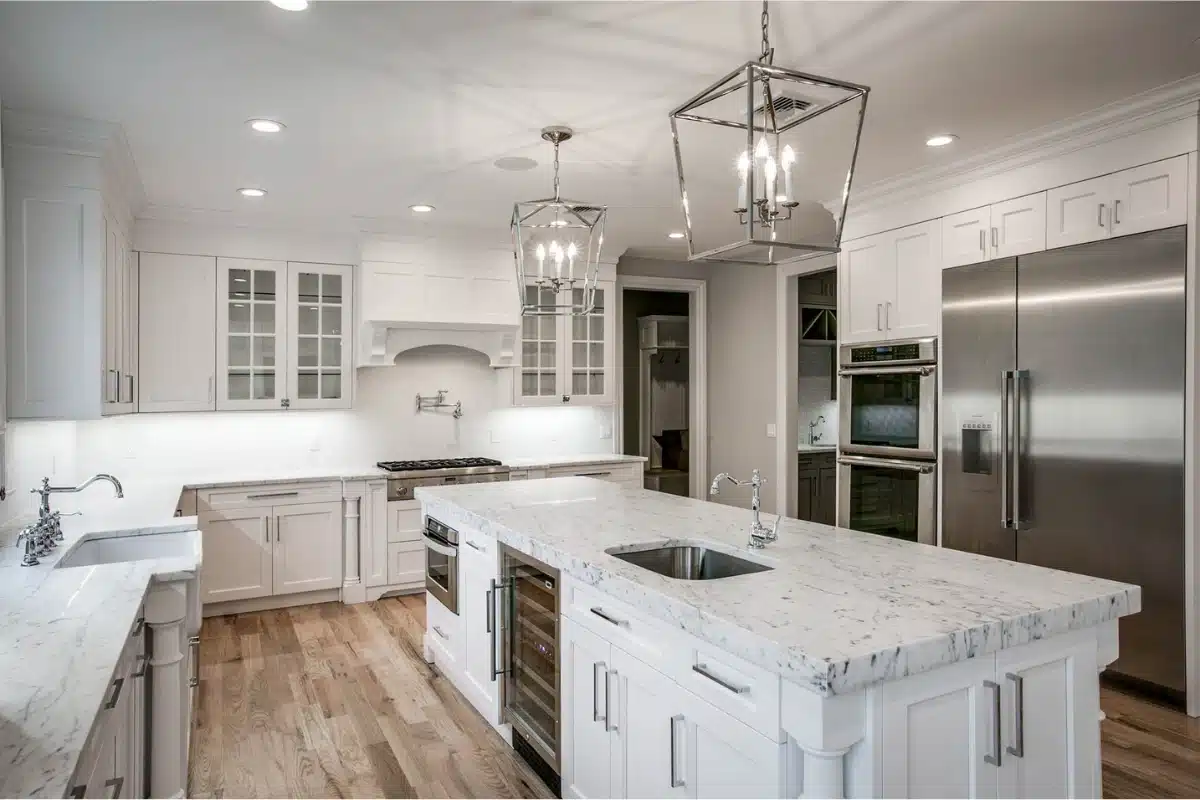Modern white kitchen featuring a waterfall quartz island during a quartz countertop installation in Baltimore MD.