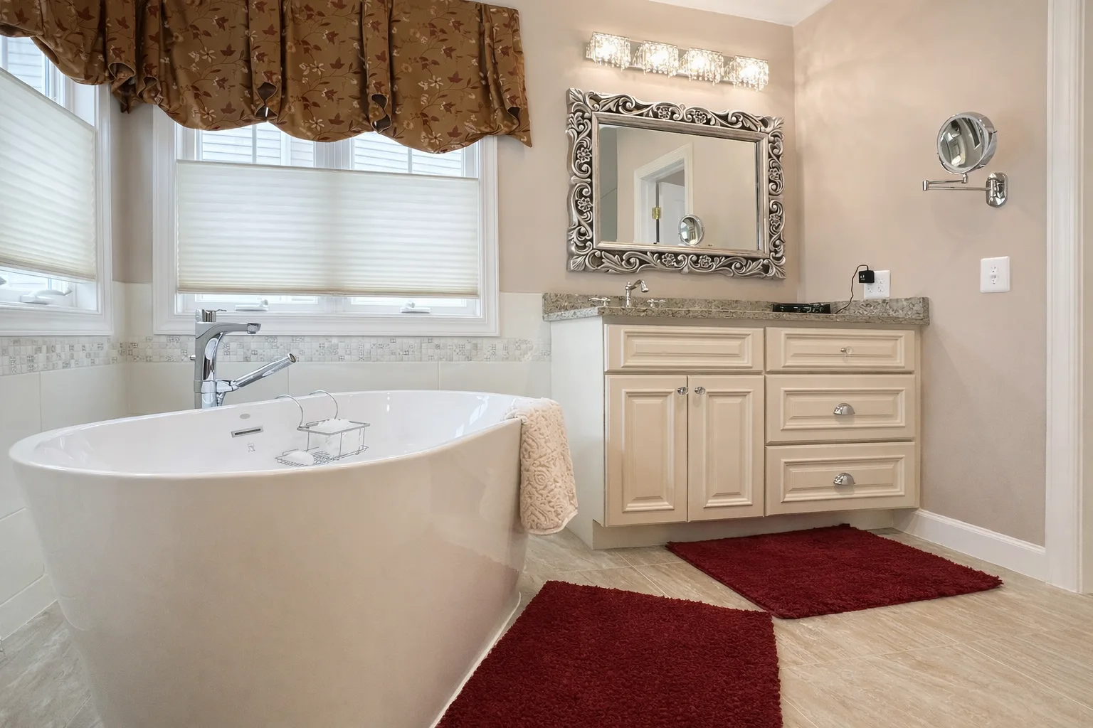 Spa-style bathroom remodeling in Baltimore, MD with a freestanding soaking tub, custom vanity, granite countertop, and elegant decorative lighting.