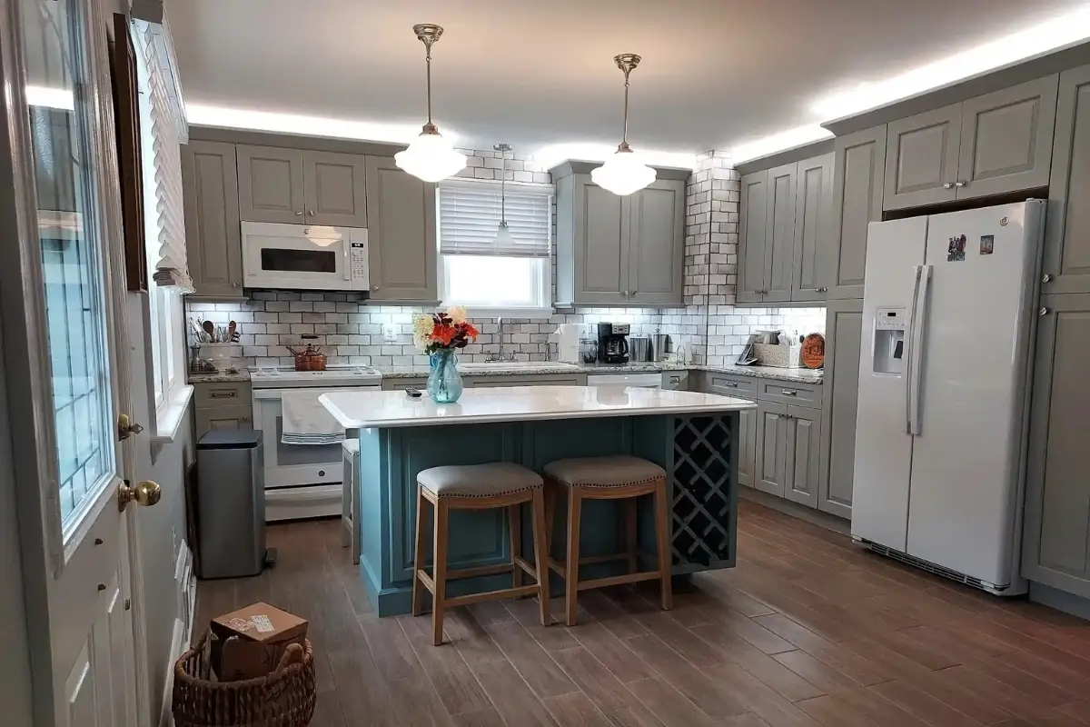 Custom kitchen remodeling in Berea, Baltimore with a large center island, pendant lighting, stainless steel appliances, and custom cabinetry.