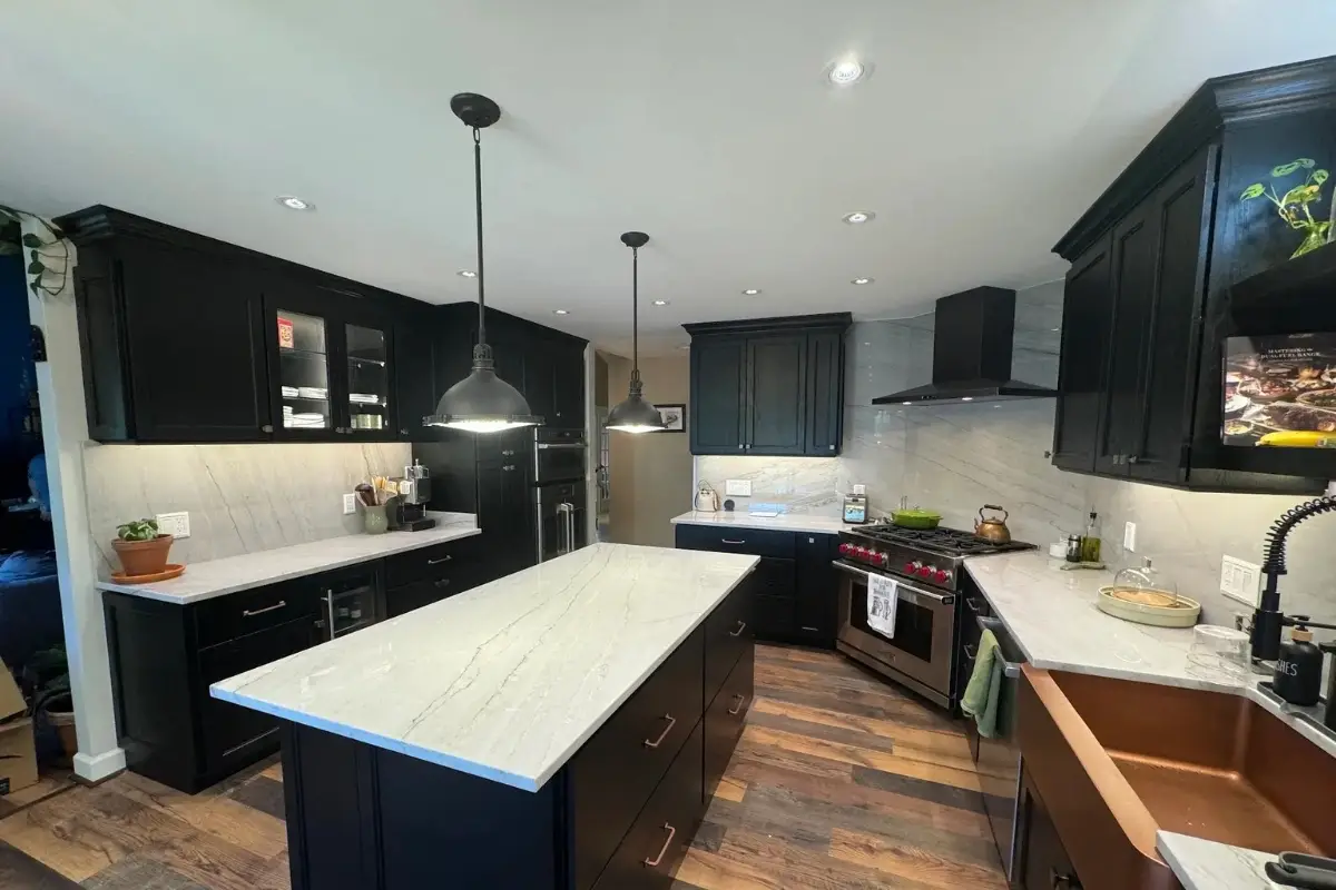 Kitchen remodeling in Mayfield, Baltimore with dark cabinets, a large center island, pendant lighting, stainless steel appliances, and a modern open layout.