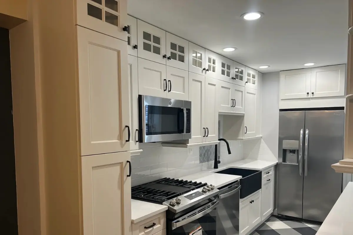 Modern kitchen remodeling project in Belair-Edison, Baltimore featuring white shaker cabinets, stainless steel appliances, and a clean contemporary design.