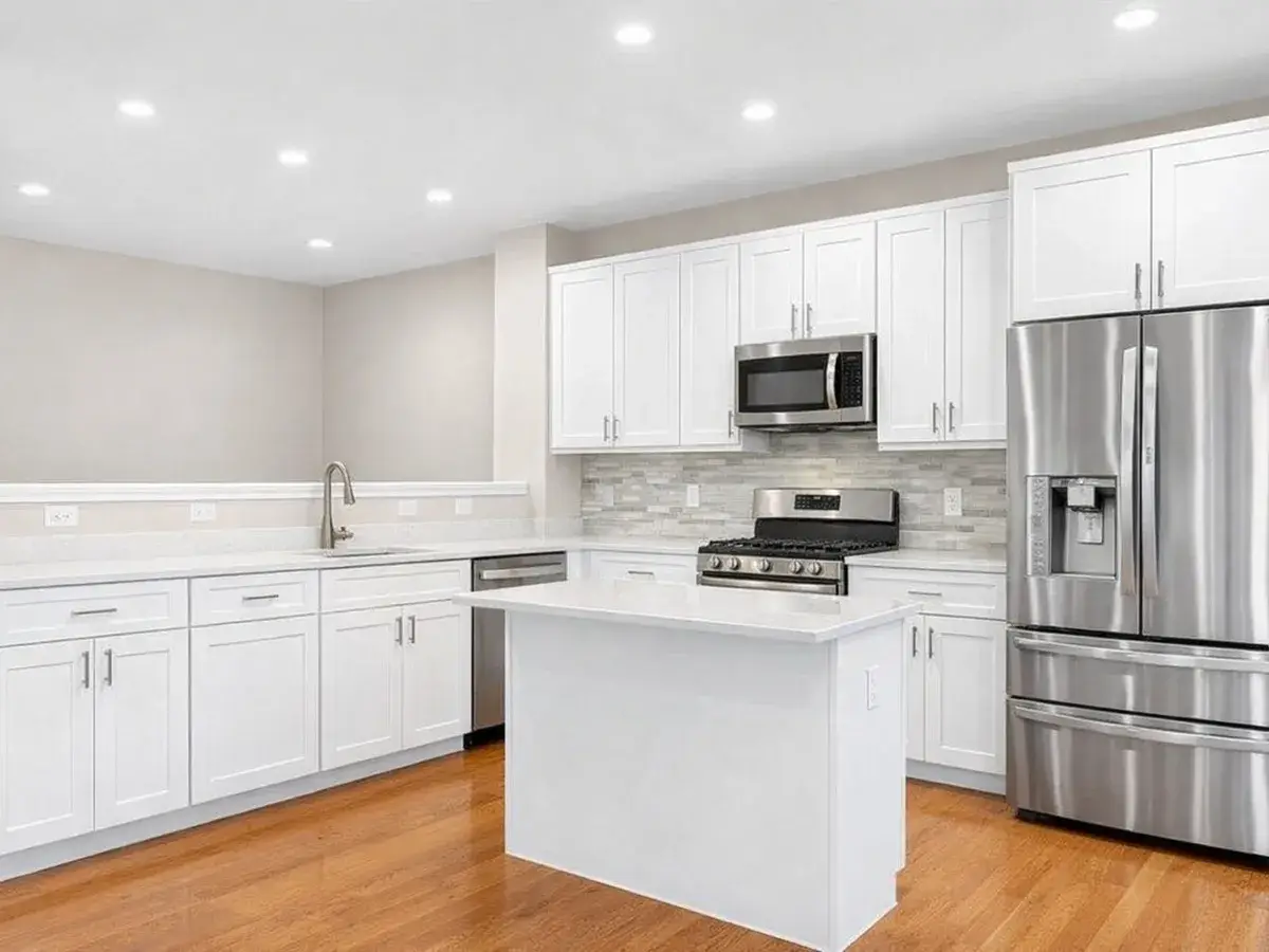 Custom white shaker cabinetry with quartz island in Canton Baltimore kitchen