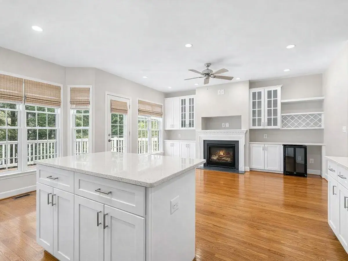 Open kitchen with island looking into living room with fireplace in Canton Baltimore